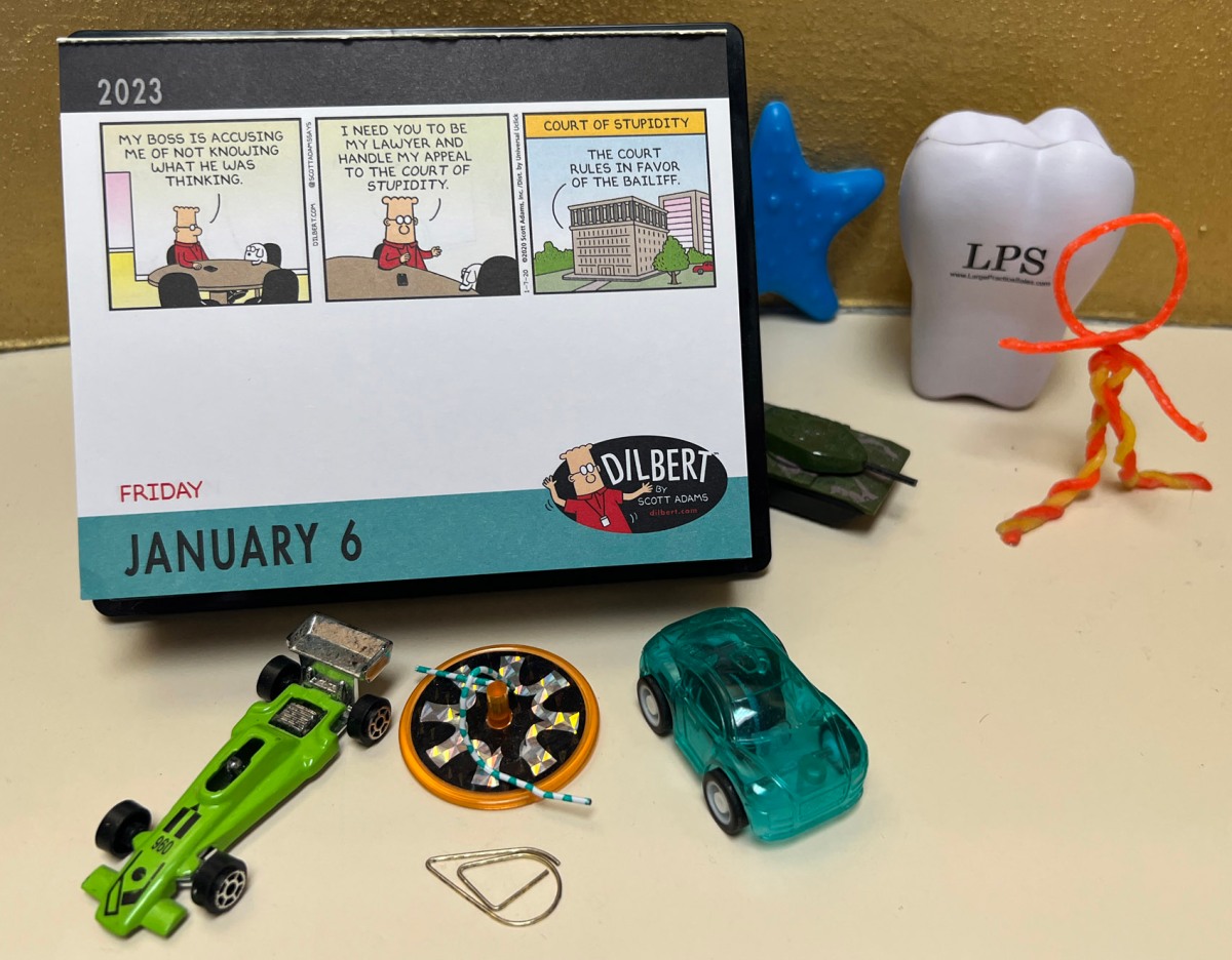 it-s-2023-so-a-fresh-dilbert-calendar-and-a-new-tooth-with-my-desk-buddies-a-gator-in-naples